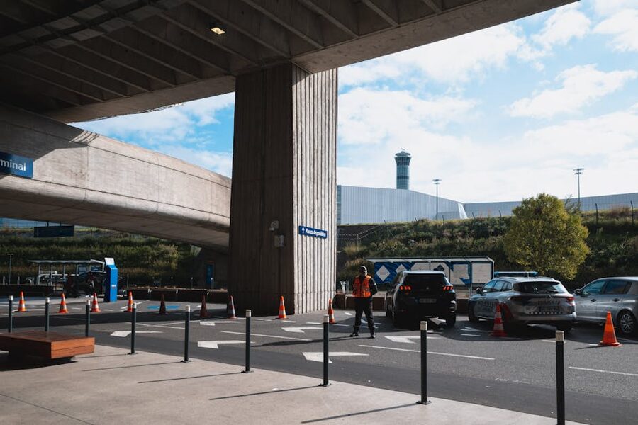 Vehicles and travellers at the Paris Charles de Gaulle airport entrance in Roissy