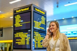 Woman calling British Airways from Gatwick Airport terminal