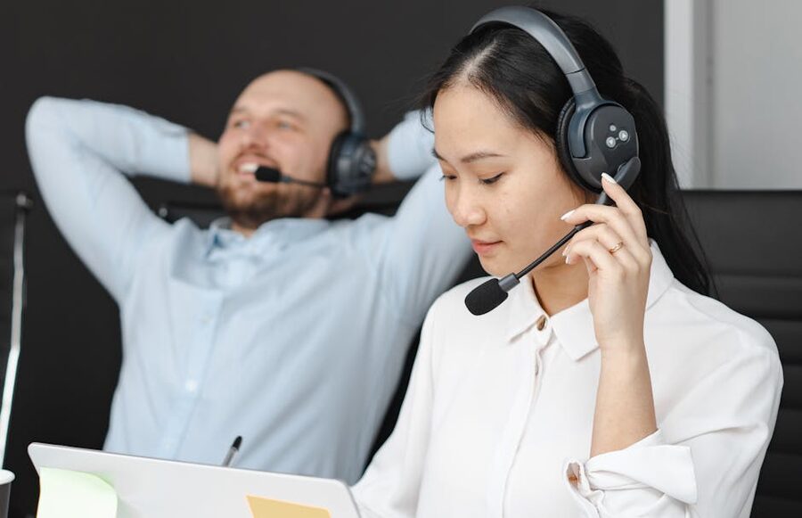 Customer service representatives wearing headsets at a call center