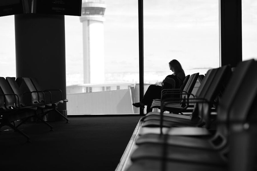 Silhouette of a passenger waiting in an airport terminal