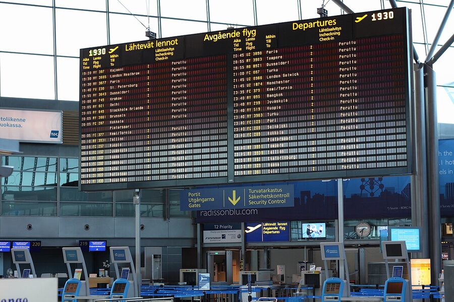 Airport departures board showing multiple cancelled flights in red