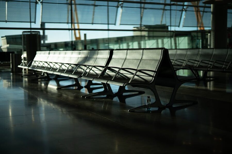 Empty airport terminal seating at dusk with sun streaming through windows