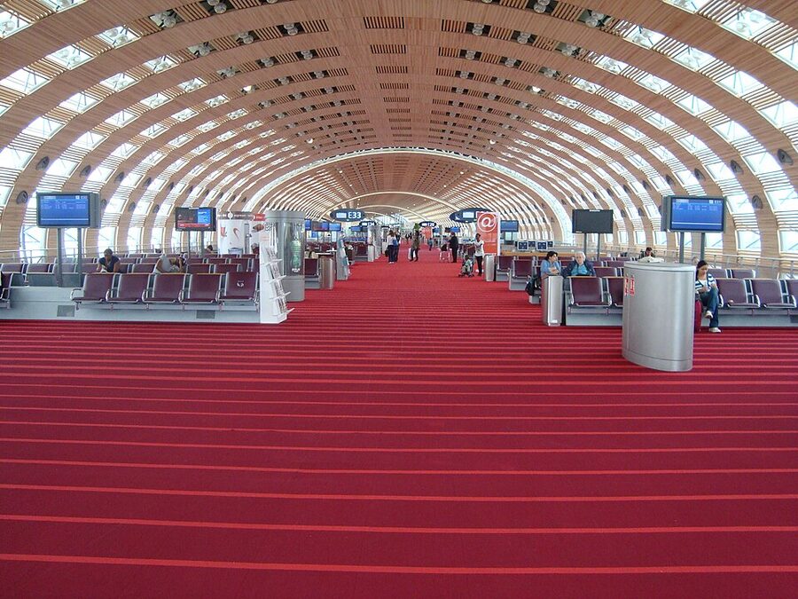 Interior of Paris Charles de Gaulle airport terminal with departure gates and passenger seating