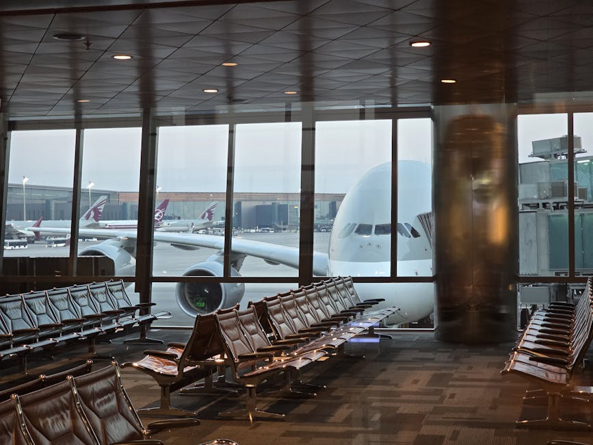 Airport gate view at Hamad International with empty seating and aircraft visible