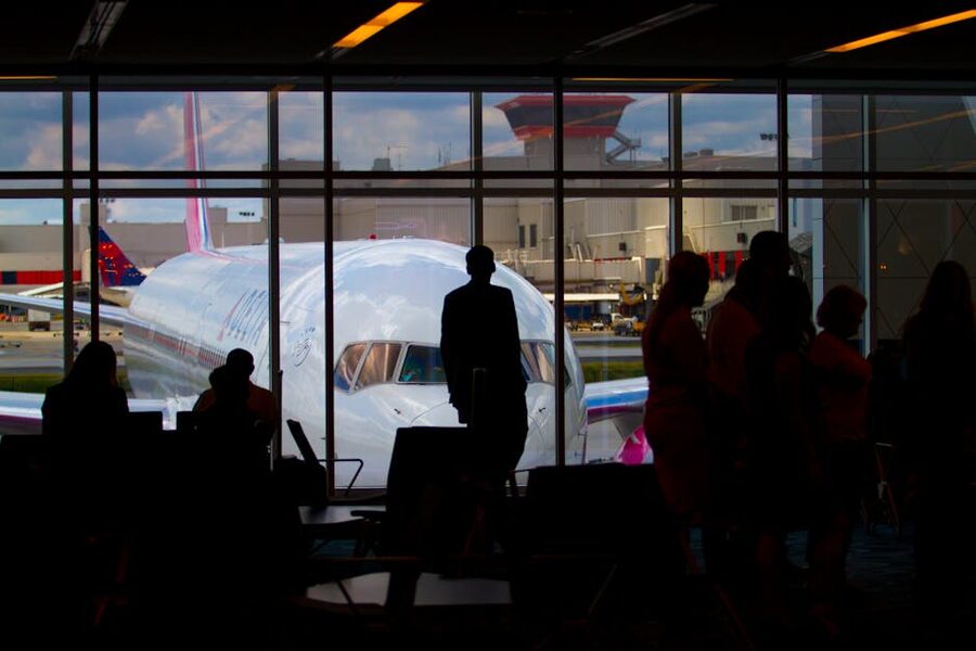 Travellers at airport terminal window