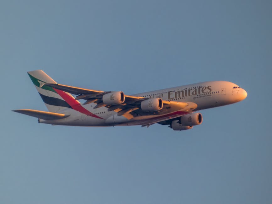 Emirates Airbus A380 flying into a sunset sky
