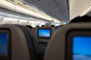 Airplane cabin interior with seatback screens