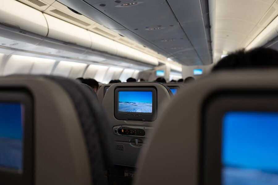 Airplane cabin interior with seatback entertainment screens