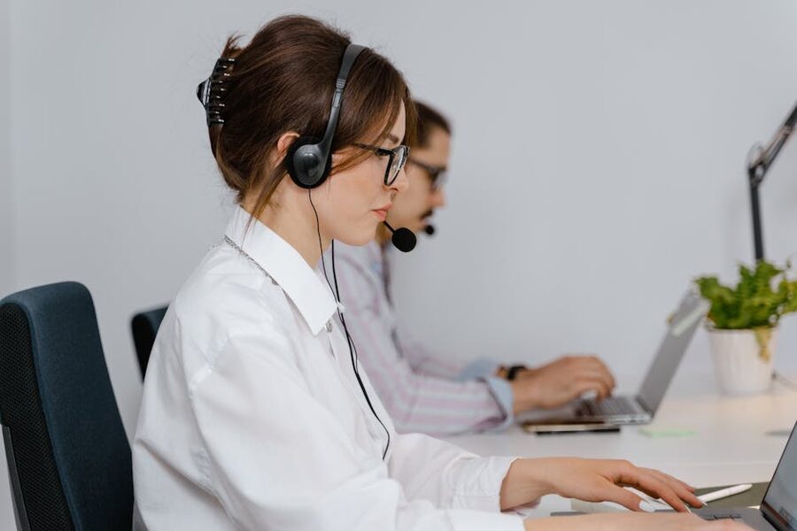Customer service agent wearing a headset at a support desk