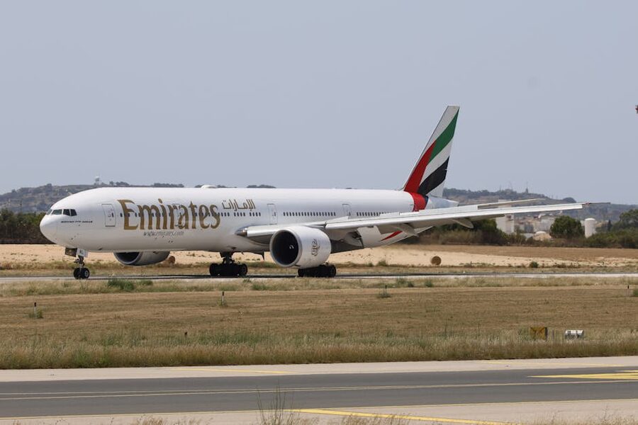Emirates Boeing 777 on a runway at sunset