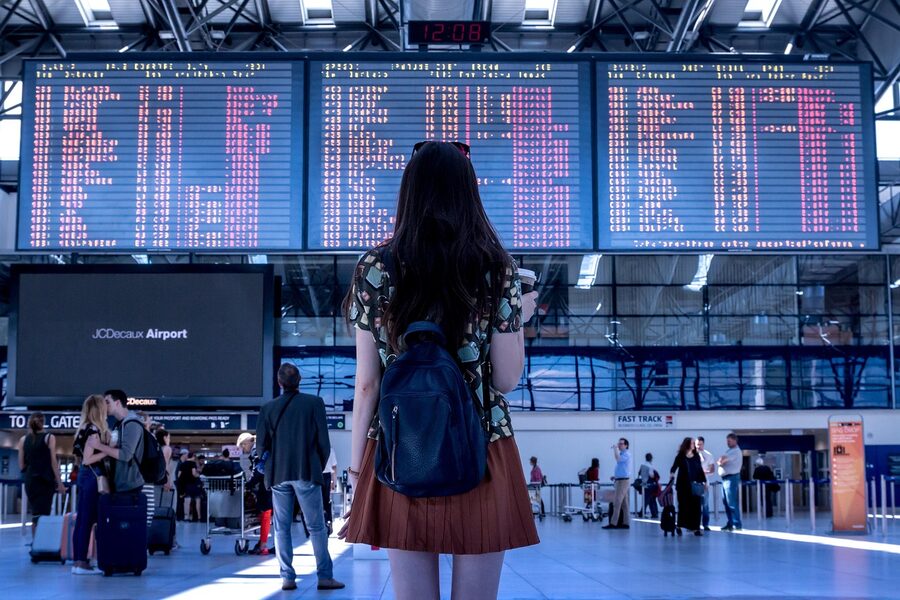Woman waiting at airport gate for flight boarding