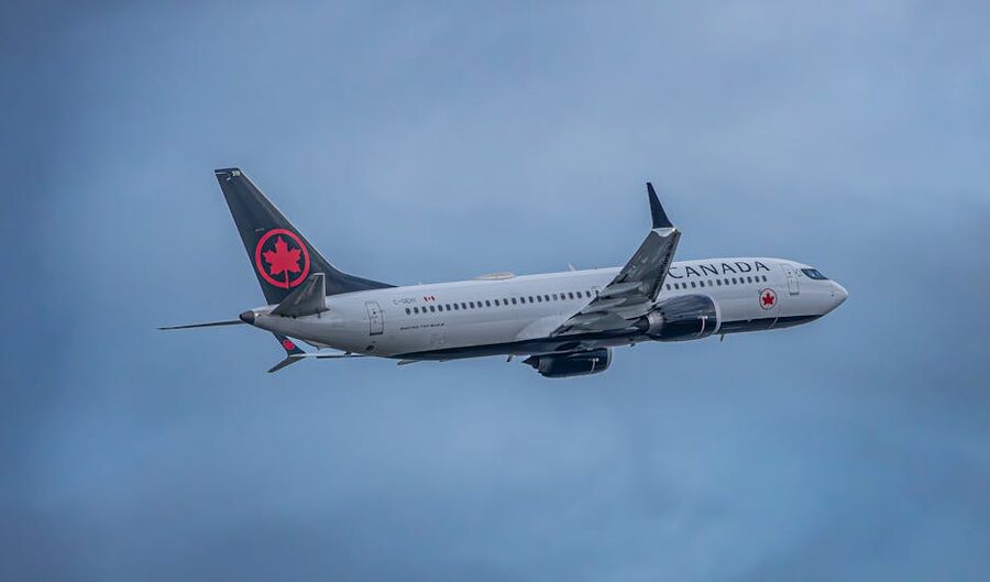 Air Canada airplane flying in a cloudy sky
