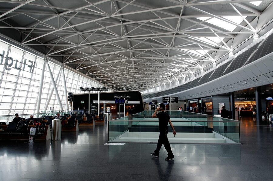Man making a phone call in the Zurich Airport departure hall