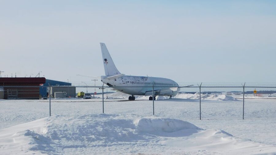 Airplane parked on a snowy runway in winter conditions