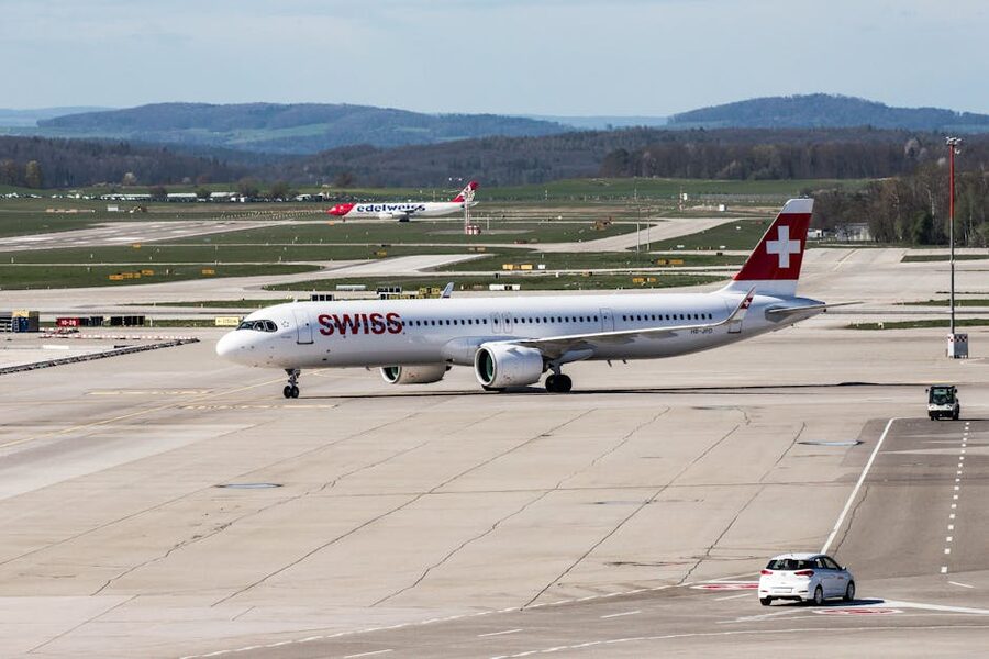 Swiss airplane on runway at Zurich Airport with mountain backdrop