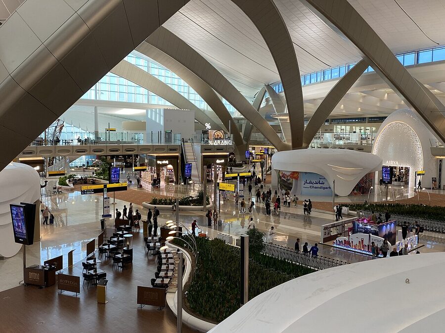 Interior concourse of Terminal A at Zayed International Airport in Abu Dhabi with shops and signage