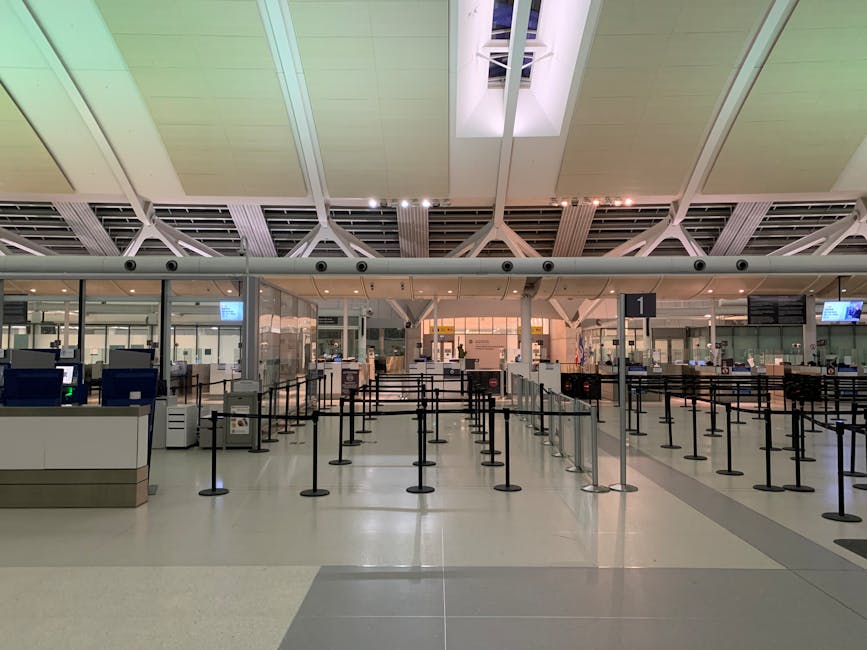 Empty modern airport check-in counters with signage ready for passengers