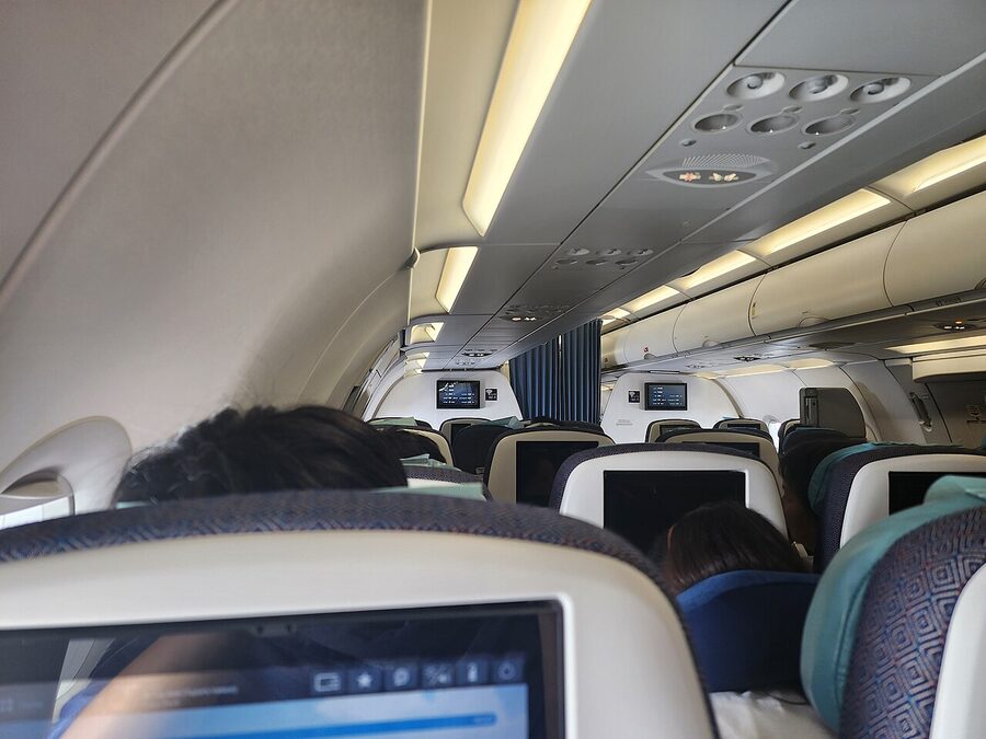 Interior economy cabin of a Philippine Airlines Airbus A321neo in flight with rows of seats visible