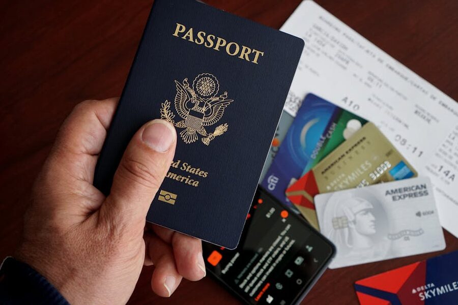 US passport, credit cards, boarding tickets, and smartphone arranged on a table before travel