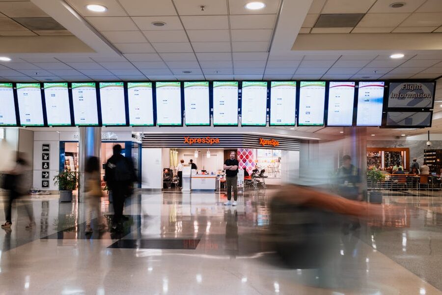 Atlanta airport terminal with flight information screens and travelers
