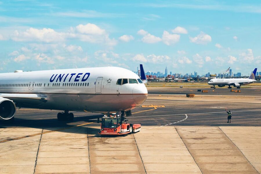 United Airlines aircraft on runway at Newark Airport with city skyline