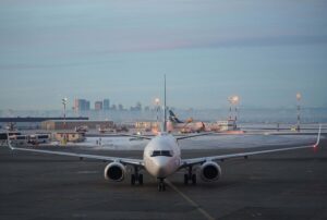 WestJet Boeing 737 parked at gate with Calgary skyline in background