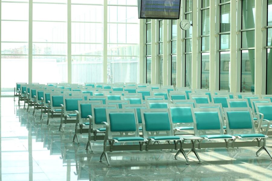 Bright modern airport waiting area with empty seats